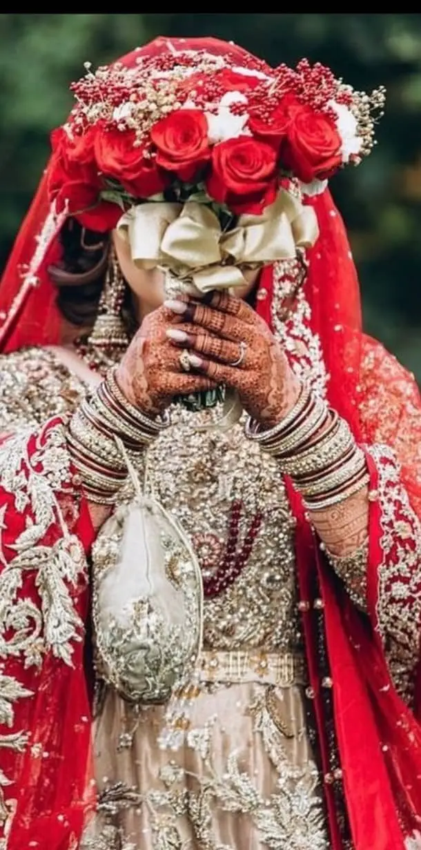 Elegant bridal bouquet with fresh roses and traditional flowers for South Asian wedding ceremony