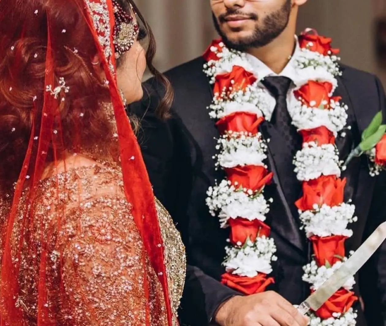 Beautiful fresh flower garland with marigolds and roses for South Asian wedding ceremony decoration